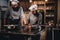 Assistant cook grinds sesame seeds in a mortar for cooking bread. Chef teaching his assistant to bake the bread in the