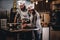 Assistant cook grinds sesame seeds in a mortar for cooking bread. Chef teaching his assistant to bake the bread in the