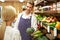 Assistant Helping Customer At Vegetable Counter Of Farm Shop