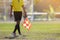 Assistant referee moving along the sideline during a soccer match.