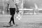 Assistant referee moving along the sideline during a soccer match.