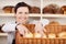 Assistant selecting rolls in a bakery