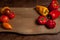 Assort of different shape and color tomatoes and bell pepper on wooden background
