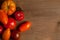 Assort of different shape and color tomatoes on wooden background