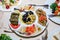 Assorted appetizers in a plate. Hummus, dolma, olives.