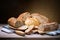 Assorted artisan bread on wooden table, space for text.