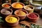 assorted ayurvedic powders in small ceramic pots