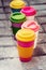 Assorted bamboo travel reusable coffee or tea cups mugs with silicone cap.