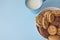 Assorted biscuits in bowl with cup milk