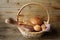 Assorted bread and sesame breadsticks in a basket on a wooden rustic table with copy space for text