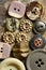 ASSORTED BUTTONS ON A FLAT STONE SLAB