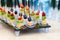 Assorted canapes of fruit and cheese on a glass platter on the background of glasses and champagne. Catering