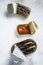 Assorted canned fish in a tin sardine, smoked sardine, mackerel. Grey wooden background. Top view