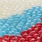 Assorted caramels of different flavors are arranged in the colors of the Russian flag. Vertical image.