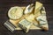 assorted cheese still life with knives and scrapers