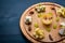 Assorted cheeses, gorgonzola, brie, feta, with honey. On a wooden background.