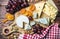 Assorted cheeses, nuts and grapes on a wooden table