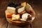 Assorted cheeses on a rustic platter