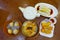 Assorted Chinese food set, dumplings, and rice noodle rolls, famous Chinese cuisine dishes on a wooden table, top view. Chinese re