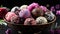 assorted chocolates in a bowl near pink roses on a black background