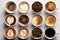 Assorted coffee cups isolated top view on beige background