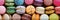 Assorted collection of vibrant macarons creating a colorful and delightful background scene