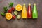 Assorted colored juices - tomato, orange, kiwi with fruits and mint leaves on a dark background. Top view, flat lay, copy space