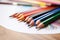 Assorted colored pencils in a row, closeup, School supplies.