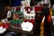 Assorted colored prayer candles and herbal medicines sold at a store outside of a church