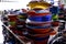 Assorted colorful ceramic and steel cooking pans