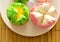Assorted colorful cotton wool cake in paper on plate