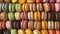 Assorted colorful macarons arranged in rows