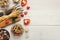 Assorted colorful pasta bowls on white wood, top view