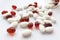 Assorted colorful pharmaceutical medicine pills, tablets and capsules with bottle on white background