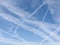 Assorted contrails aka vapour trails in sky