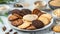 Assorted Cookies with Edible Insects. A plate of assorted chocolate chip and butter cookies, whimsically decorated with