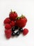 assorted delicious berries on a white background - strawberries, raspberries, black currants