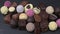 Assorted delicious chocolate pralines. Selection of pralines with milk and dark chocolate on slate rotating tray. Loving