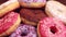 Assorted delicious donuts on rustic wooden background