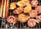 Assorted delicious grilled meat over the hot fire on a portable barbecue with steaks, sausages, chicken.