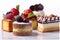 Assorted different mini cakes with cream, chocolate and berries