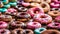 assorted donuts with chocolate frosted, pink glazed and sprinkles donuts.