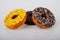 Assorted donuts with chocolate frosted, yellow glazed and sprinkles donuts