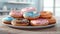 Assorted donuts with colorful icing and sprinkles on a plate.