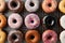 Assorted donuts displayed on kitchen table, tempting pastry delights