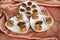 Assorted dry fruit Indian sweets with dry figs in three plates on a satin fabric