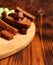 Assorted dry snacks on a wooden board. Chips, peanuts, croutons, wasabi