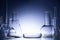 Assorted empty laboratory glassware, test-tubes. Blue tone medical background. Copy space