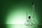 Assorted empty laboratory glassware, test-tubes. Green tone medical background. Copy space
