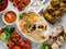 Assorted famous indian and pakistani food table vegetable biryani, Butter Chicken, paneer Chicken Tikka boti kebab, lime, Kali